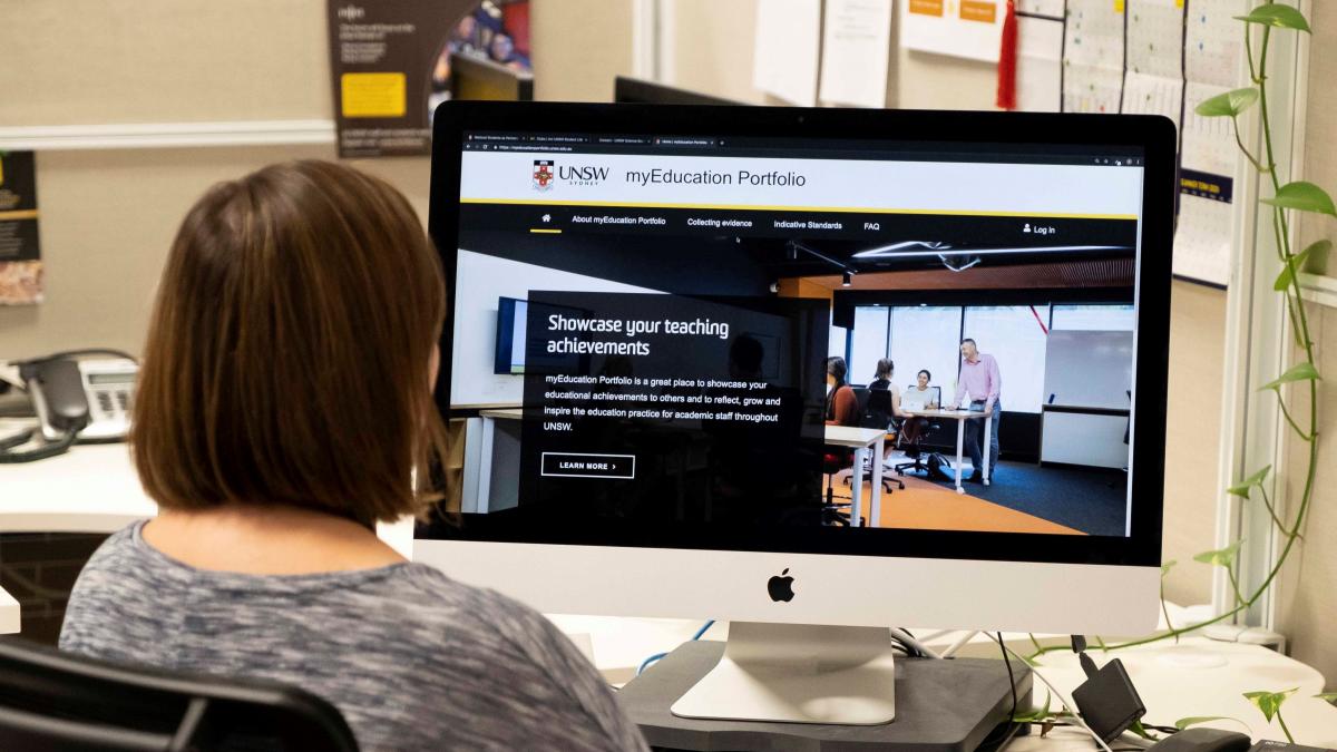 photo of women looking at a co,puter screen