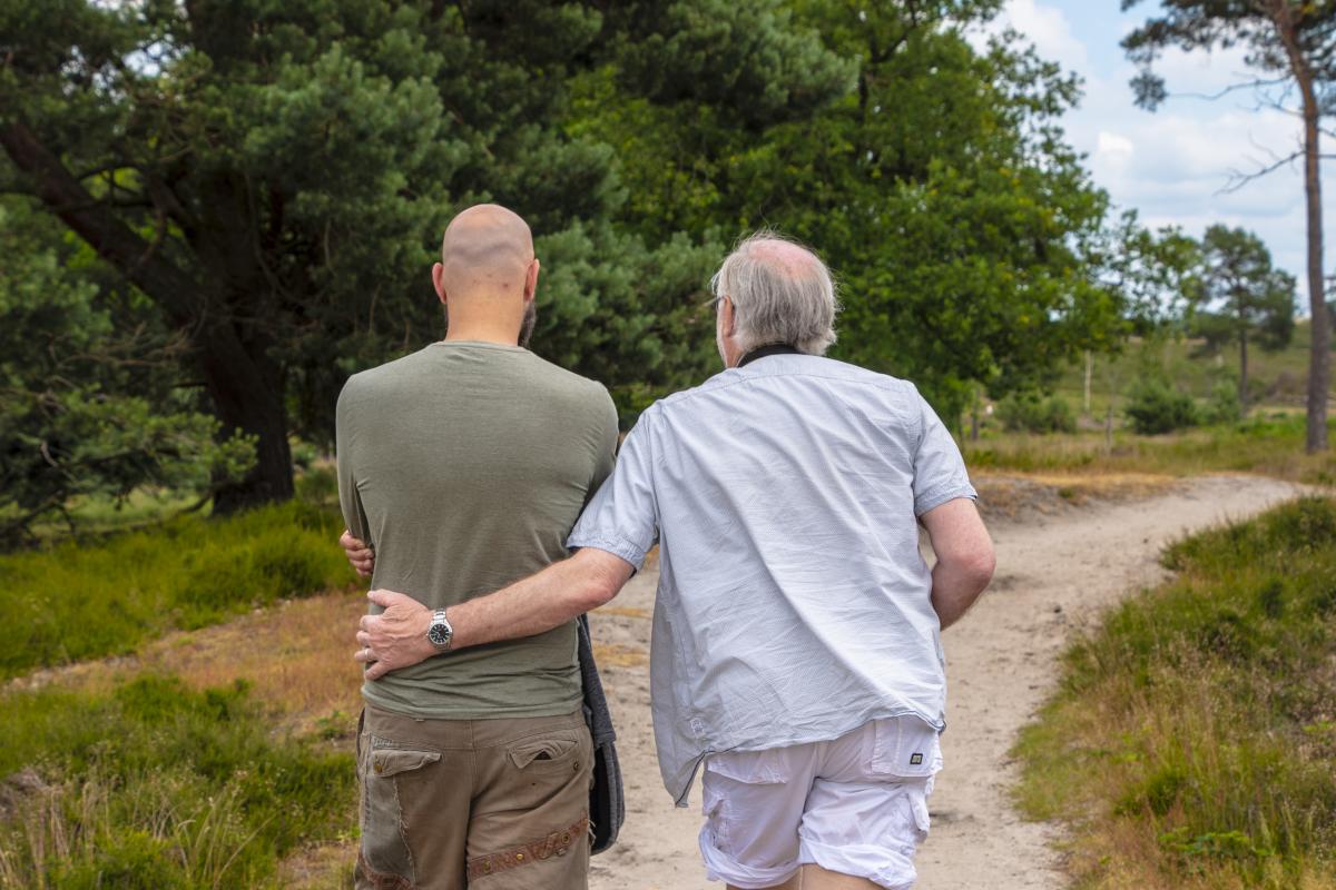 photo of thebacks of two men walking outside